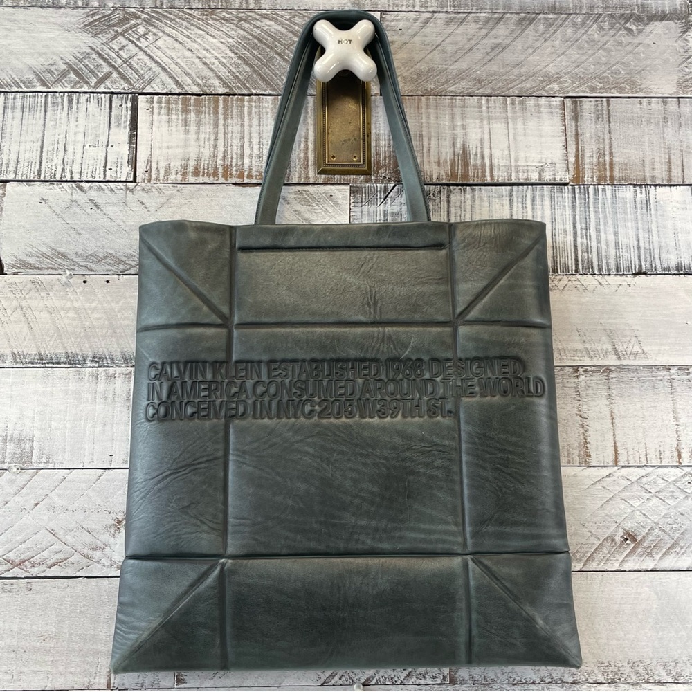 Calvin Klein gray blue leather tote bag with words established 1968